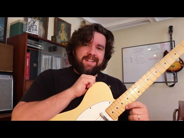 Joe Dampt seated with a vintage Fender Telecaster